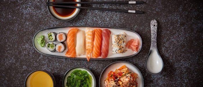 asian-food-assortment-various-sushi-rolls-placed-ceramic-plates-kimchi-goma-wakame-salads-soy-souce-chopsticks-sides-grungy-dark-background-with-copy-space (2)